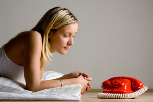 Teenager looking at red phone